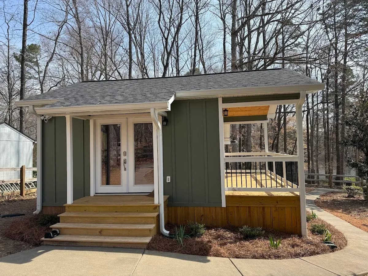 Illuminated Steps & Covered Patio by Alex's Lawnscape in Charlotte NC — Stunning nighttime shot of illuminated stone retaining wall steps and paver walkway alongside a covered patio with string lights