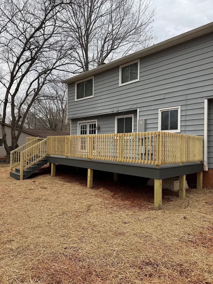 Lakefront Evening Showcase by Alex's Lawnscape in Charlotte NC — Beautiful nighttime view of lit stone steps, retaining walls, gazebo, and dock at a waterfront property