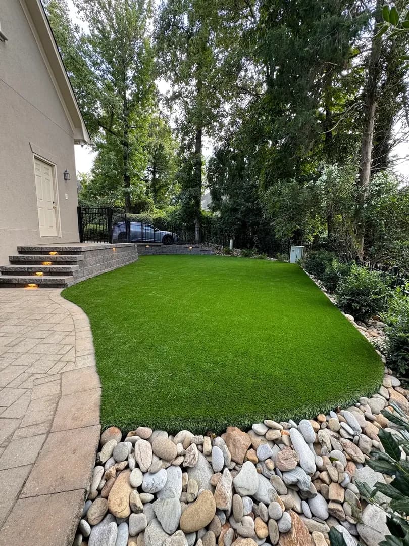 Pergola on Elevated Paver Patio by Alex's Lawnscape in Charlotte NC — Timber pergola on elevated paver patio with block retaining wall steps and fresh mulch beds