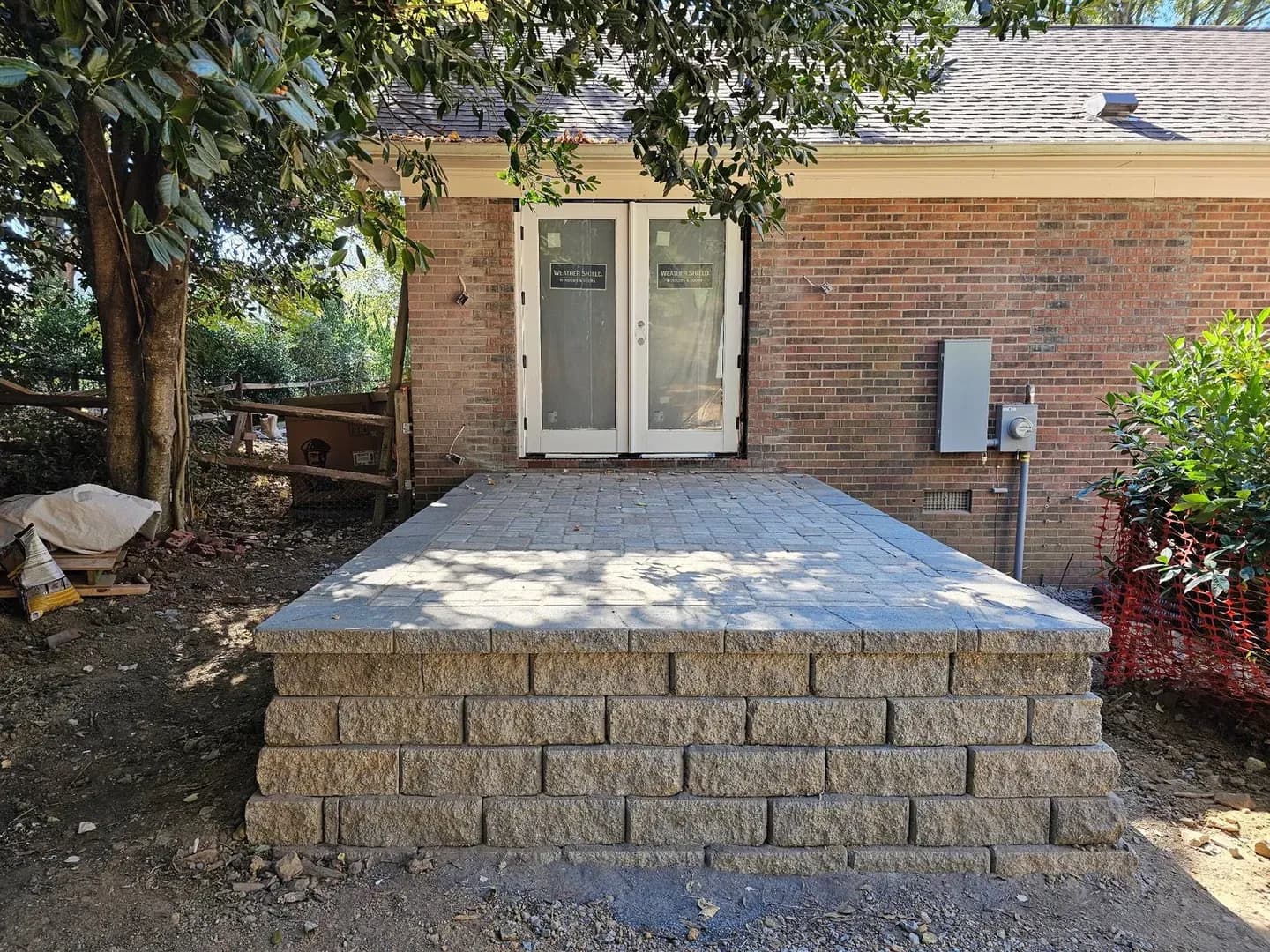 Covered Multi-Level Patio by Alex's Lawnscape in Charlotte NC — Covered raised paver patio with pergola roof structure, retaining wall steps, and multi-level design