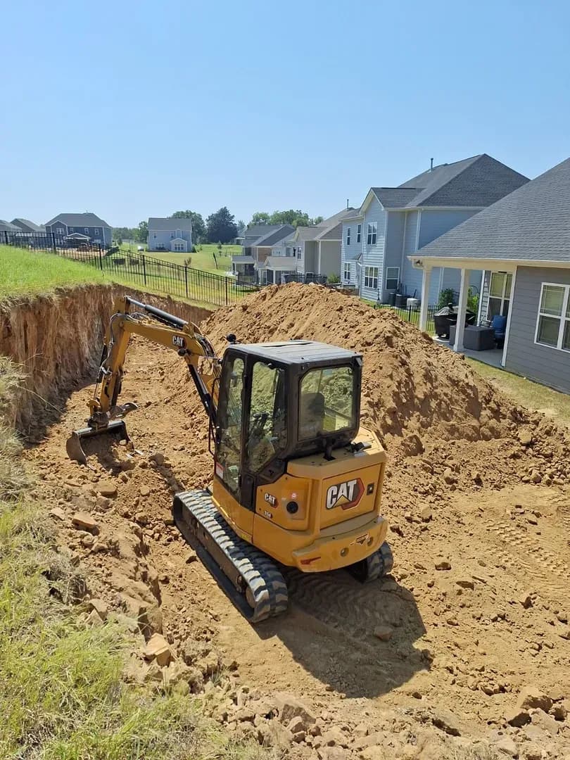 Cascading Rock Water Feature by Alex's Lawnscape in Charlotte NC — Multi-tier cascading water feature built with stacked natural stone and river rock, with accent plantings and a flagstone border